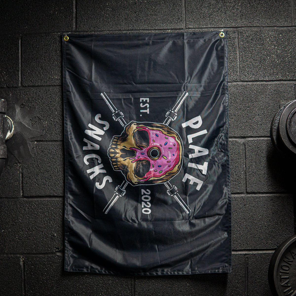 Plate Snacks donut skull design on a black flag in basement gym
