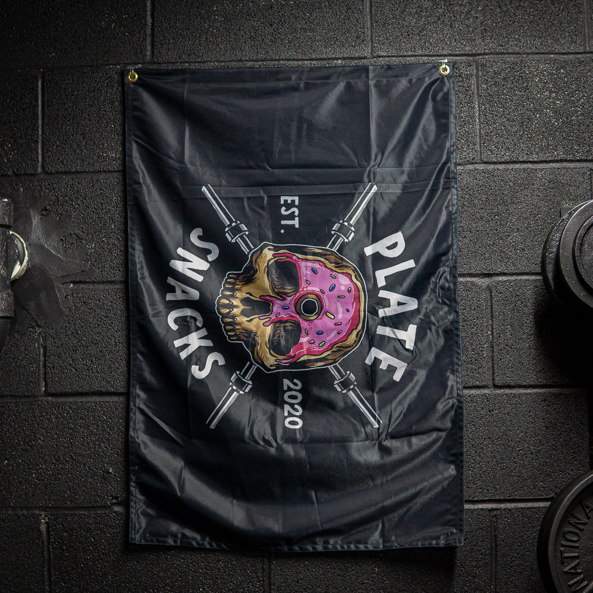 Plate Snacks donut skull design on a black flag in basement gym